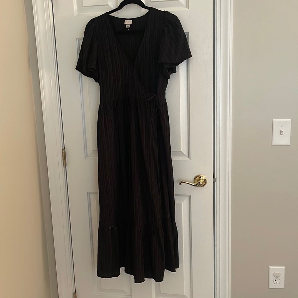 Black wrap dress with flutter sleeves.